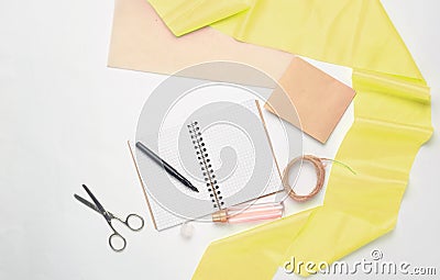 Flat lay from a notepad, pens, scissors, perfume bottle Stock Photo