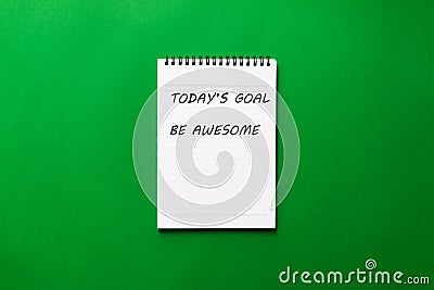 Flat lay of notepad with text written - Today`s goal, Be awesome on green background Stock Photo