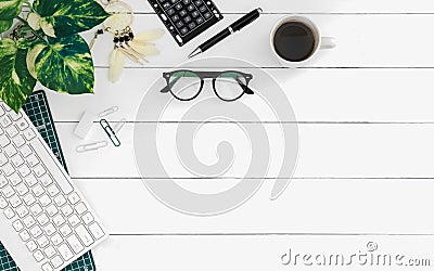 Flat lay of office desk work space table with computer wireless keyboard and stationary in home office on white wood table. Top Stock Photo