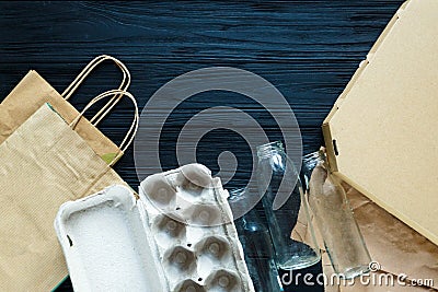 Flat lay of paper wastes as bags, boxes ready for recycling on gray background Stock Photo