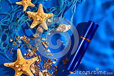 Flat lay perfume bottle of water background with starfish, sea or ocean shells Stock Photo