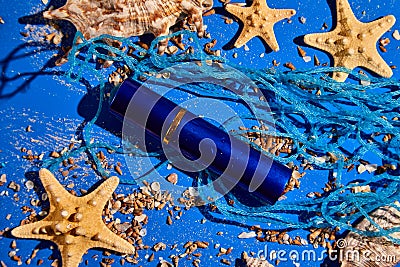Flat lay perfume bottle of water background with starfish, sea or ocean shells Stock Photo