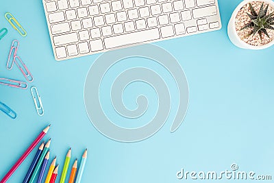 Flat lay photo of office desk with pencil and keyboard ,top view workpace on blue background and copy space Stock Photo