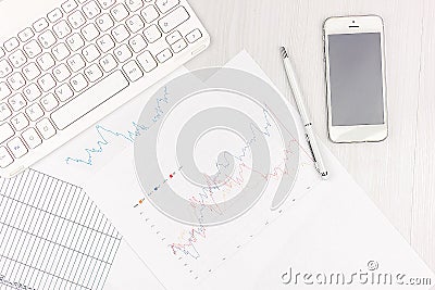 Flat lay photo of white office desk with laptop, smartphone, eyeglasses, notebook and pen with copy space background. Mockup Stock Photo