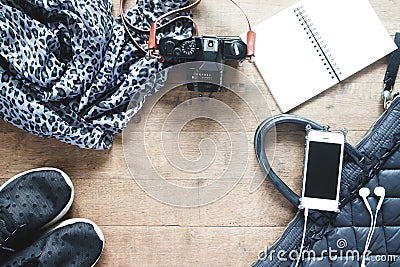 Flat lay photography with cellphone, travel accessories, essential items for woman, Overhead view, top view on wood background Stock Photo