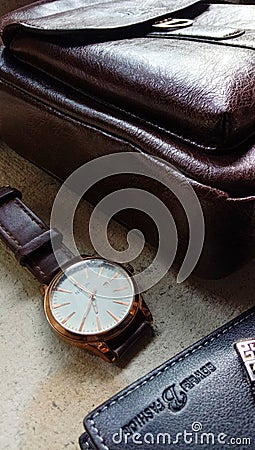 Flat lay photos of men`s products in the form of watches, leather wallets and bags as well as a cup of coffee Editorial Stock Photo