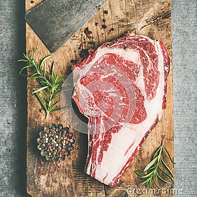 Raw prime beef meat steak rib-eye and chopping knife, flat-lay Stock Photo