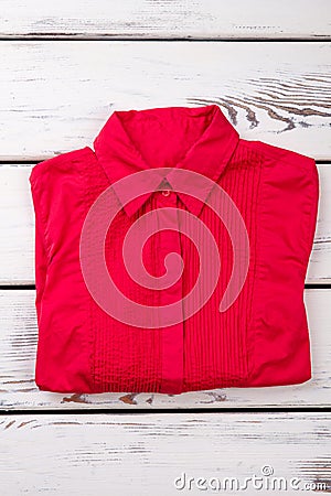 Flat lay red women shirt on wooden background. Stock Photo