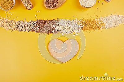 Flat lay of set of heap various grains and cereals on yellow background Stock Photo