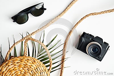 Flat lay stylish summer female fashion outfit and accessories on white background. Top view rattan bag, sunglasses, vintage photo Stock Photo