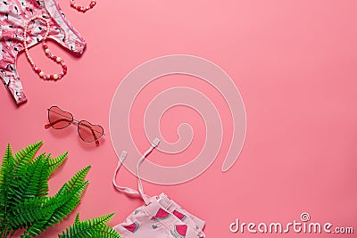 Flat lay with summer accessories. Children's summer accessories, sunglasses, swimsuit, shorts, tropic leaves with copy Stock Photo