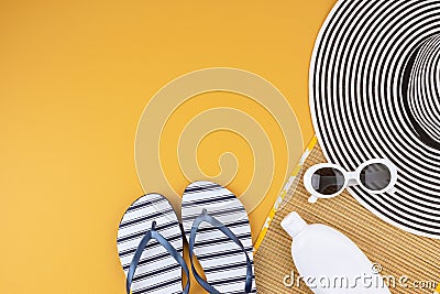 Flat lay with summer accessories for woman. Sun hat, sunglasses, sunscreen protection, flip flops and bag. Summer travel, Stock Photo