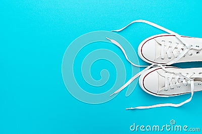 Flat lay top-down composition of pair of white untied sneakers Stock Photo