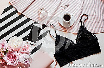 Flat lay. Top view black lace lingerie. Beauty blog concept. Bouquet of roses and pions, coffee on white background Stock Photo