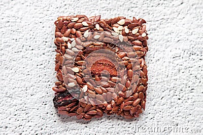 Flat lay top view one crunchy flax seed crispbread with dry beetroot on white background with copy space Stock Photo