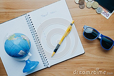 Flat lay travel concept with coins, cards, mobile phone, globe a Stock Photo