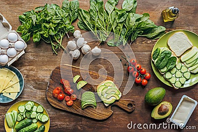 flat lay with various arranged healthy vegetables, mushrooms and raw chicken eggs for cooking breakfast Stock Photo