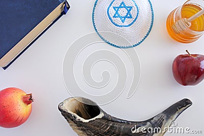 Flat lay view of Shofar, Torah book, Kippa, apple, honey and Pom Stock Photo