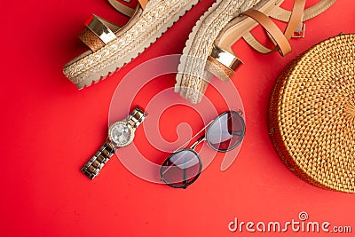 Flat lay, Wicker fashion bag, sunglasses, tropical bananas and expensive watches and women`s shoes. Summer fashion, the concept o Stock Photo