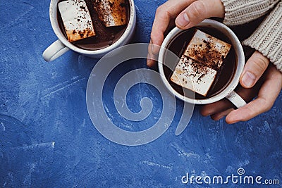 Flat lay of woman`s hands in sweater and two cups of cocoa or hot chocolate Stock Photo
