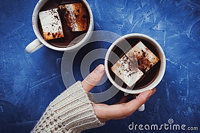 Flat lay of woman`s hands in sweater and two cups of cocoa or hot chocolate with homemade vegan marshmallow Stock Photo