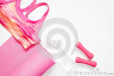 Flat lay of woman sport and yoga equipments in pink color on white background Stock Photo