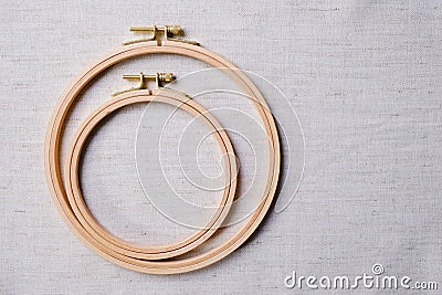 Flat lay with wooden embroidery hoops on a canvas background. Top view Stock Photo