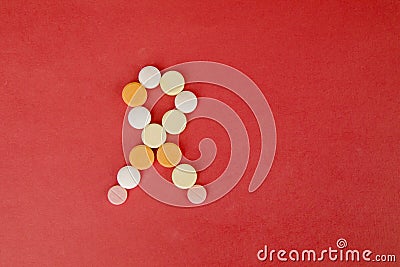 Flat lay of arranged pills making shape of ribbon Stock Photo