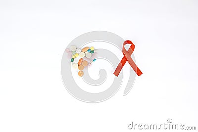 Flat lay of red ribbon besides heart shaped pills Stock Photo
