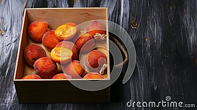 Flat peach in a wooden box on a dark background. Top view. Free space for your text. Seasonal harvest crop local produce concept Stock Photo