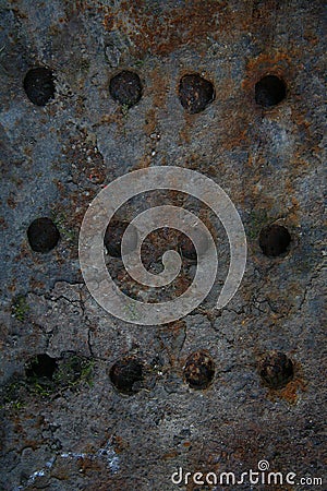 Flat sheet of rusty iron cast iron with horizontal rows of round holes. Highly Detailed Grunge Metal Background Texture. Stock Photo