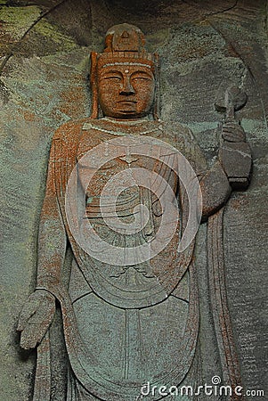 Flat standing Buddha carved from rock Stock Photo