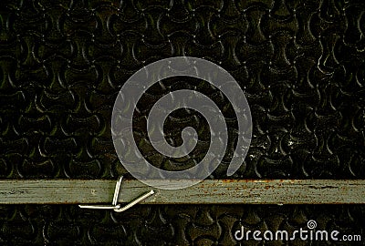 Flat steel wire tied to grunge rubber foam sheet. Stock Photo