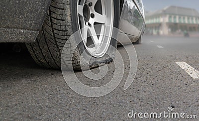 Flat tire car on side of street because expired tyre Stock Photo