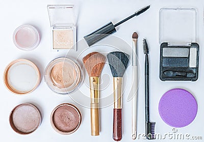 Flat view on cosmetics, makeup and brushes on white background Stock Photo