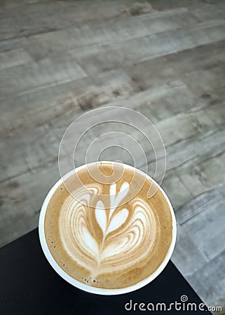 Flat white coffee in a cafe latte art on wooden floor Stock Photo