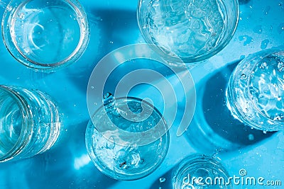 Splashing sparkling water in various glasses , summer drink concept Stock Photo