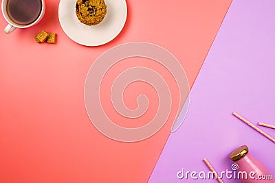 Flatlay with a blueberry muffin and cup of tea on one side and bottle of juice or smoothie with straws on the opposite side. Stock Photo