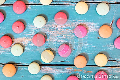 Flatlay, colorful cookies or macarons spread out of a blue wooden background Stock Photo