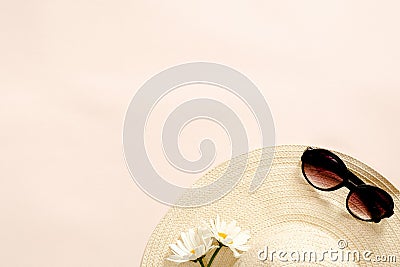 Flatlay composition with straw hat, daisy flowers and sunglasses on pastel pink background. Flat lay, top view, copy space. Summer Stock Photo