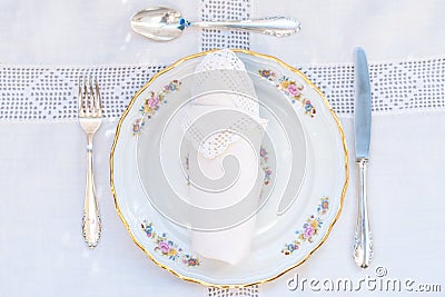 Flatlay of a dessert set: porcelain plates with silver cutery an Stock Photo