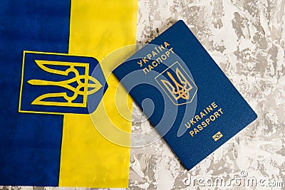 Ukraine, Chernihiv, July 5, 2023: Flatlay, flag of Ukraine with coat of arms and passport of citizen of Ukraine on light Editorial Stock Photo