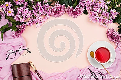 Flatlay frame arrangement with pink chrysanthemum flowers, hibiscus tea, pink scarf, glasses and notebook Stock Photo