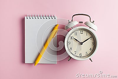 Notebook, pen, alarm clock. Blank card for to-do list, timetables, text, design. Concept of time, deadline. Copy space Stock Photo