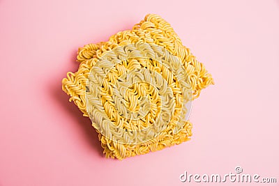 Flatlay, paper background with copy space. Two large servings of instant noodles on a pink background. Stock Photo