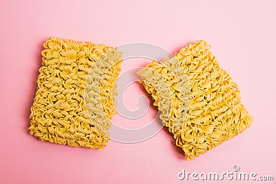 Flatlay, paper background with copy space. Two large servings of instant noodles on a pink background. Stock Photo