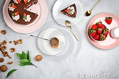 Flatlay with vegan chocolate cake, strawberries, walnuts, cocoa and other dessert ingredients Stock Photo