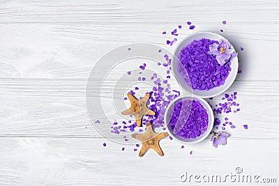 Flavored purple sea salt crystals with violet flower and starfishes on white Stock Photo