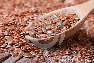Flax seeds close up on a wooden spoon on a table Stock Photo
