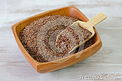 Flax seeds in wooden bowl Stock Photo